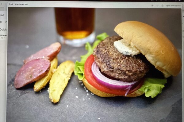 A beautiful and delicious ground ostrich burger on a brioche.